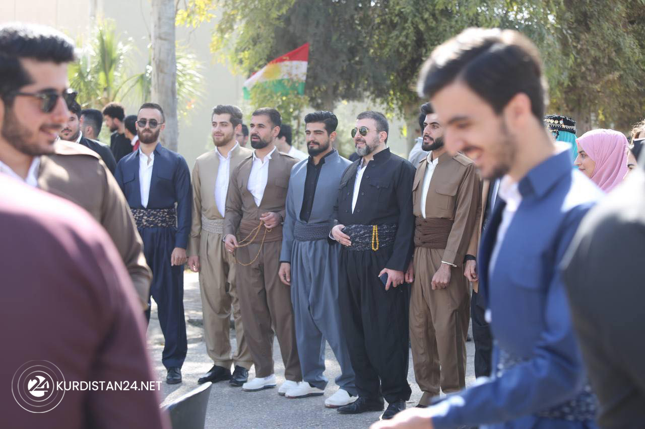A number of students pose for a group photo in Kurdish clothes on National Clothing Day, March 10, 2022. (Photo: Islam Hero/Kurdistan24)